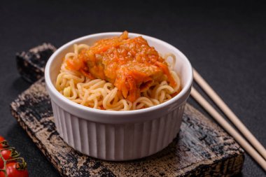 Koyu beton arka planda balık ve soslu pirinç eriştesi, tuz ve baharat.