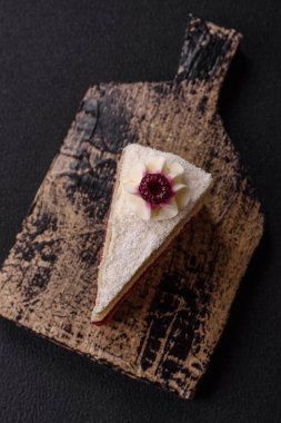 Üzerinde hindistancevizi serpiştirilmiş ahududu reçeli, koyu beton kaplama tatlı bir pasta.