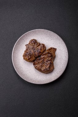 Tuz, baharat ve otlarla kaplanmış, koyu dokulu ızgara biftek.