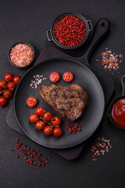 Tuz, baharat ve otlarla kaplanmış, koyu dokulu ızgara biftek.