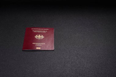 Almanya vatandaşının uluslararası pasaportu koyu beton arka planda, uluslararası seyahat