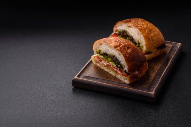 Jambonlu ciabata veya prosciutto, domates, peynir ve tuzlu, baharatlı ve otlu marul.