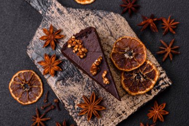 Koyu beton arka planda fındıklı bir parça çikolatalı pasta.