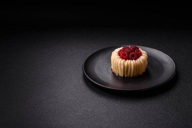 Ahududulu tatlı kremalı tart ve koyu beton bir arka plan