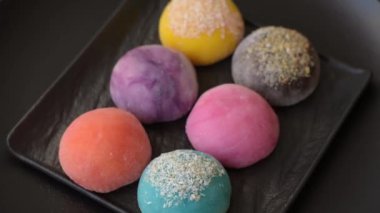 Lezzetli Asya mochi tatlısı pirinç hamuru kabuğu ve koyu beton arka planda meyveler.