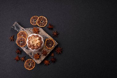 Koyu beton arka planda kremalı, fındıklı tatlı puf tart.