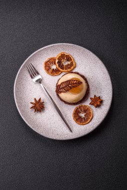 Armut limonlu kremalı tatlı tart ve koyu beton arka planda çikolatalı kek tabanı.