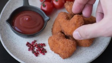 Delicious fresh crispy chicken nuggets on a dark concrete background. Unhealthy food, fast food