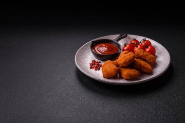 Delicious fresh crispy chicken nuggets on a dark concrete background. Unhealthy food, fast food