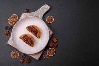 Koyu beton bir arka planda kremayla kaplı tatlı Danimarka çöreği.