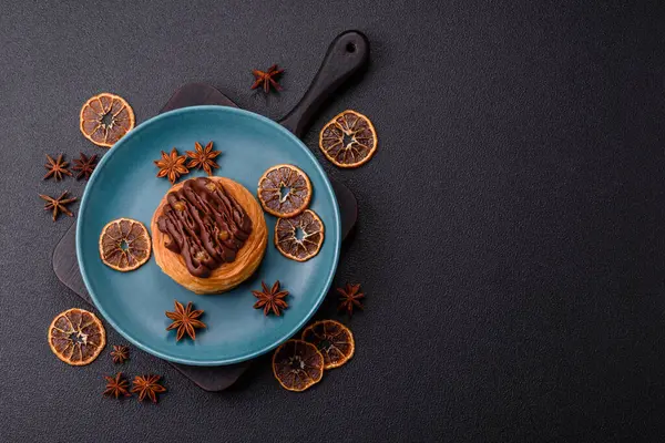 Koyu beton bir arka planda kremayla kaplı tatlı Danimarka çöreği.