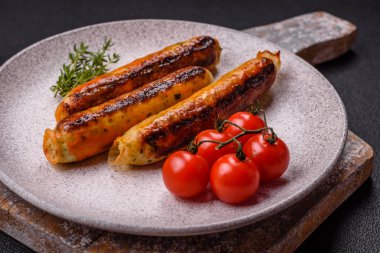 Koyu beton arka planda tuz, baharat ve otlu tavuk veya domuz sosisi.