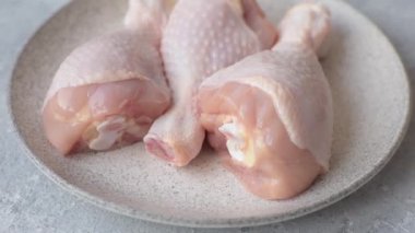 Çiğ tavuk budu, tuzlu, baharatlı ve ızgara için hazırlanmış otlar.