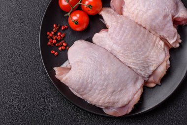 Çiğ tavuk butları, tuzlu, baharatlı ve ızgara için hazırlanmış otlar.