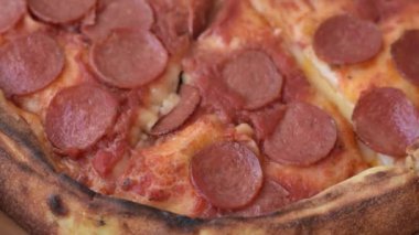 Sosisli biberli pizza, mozzarella peyniri, domates, tuz ve baharatlar koyu beton arka planda.