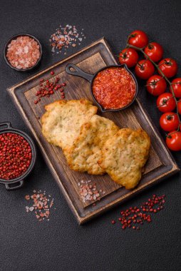 Lezzetli kızarmış domuz ya da koyu beton arka planda tuz ve baharatla ekilmiş tavuk pirzolası.