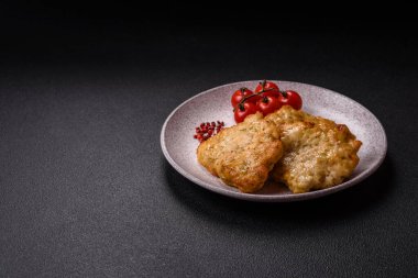 Lezzetli kızarmış domuz ya da koyu beton arka planda tuz ve baharatla ekilmiş tavuk pirzolası.