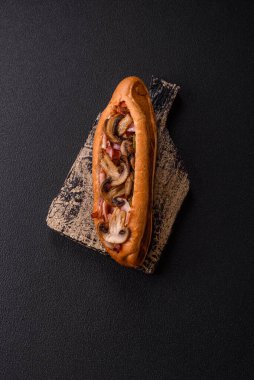 Kızarmış sosisli, domuz pastırması ve mantarlı, tuzlu, baharatlı ve otlu sandviç.