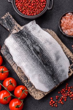 Ringa fileto tuzlu ve tuzlu, baharatlı ve yağlı koyu beton arka planda.