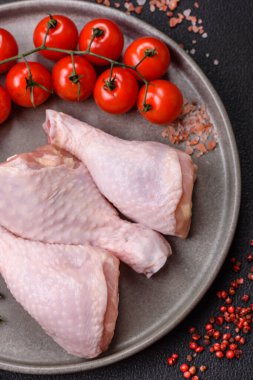 Tuzlu, baharatlı, otlu ve domatesli çiğ tavuk budu.