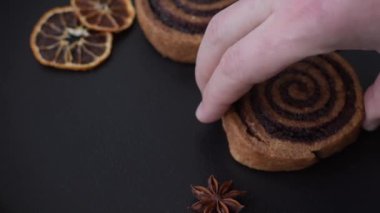 Beyaz krema ve turunçgille kaplı tatlı Danimarka çöreği. Koyu beton bir arka planda krema doluyor.