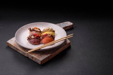 Lezzetli Asya mochi tatlısı pirinç hamuru kabuğu ve koyu beton arka planda meyveler.