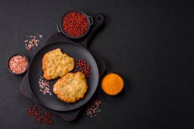 Lezzetli kızarmış domuz ya da koyu beton arka planda tuz ve baharatla ekilmiş tavuk pirzolası.