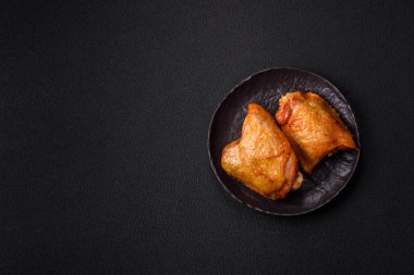 Koyu beton arka planda tuz, baharat ve otlarla kızartılmış tavuk butları.