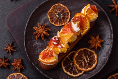 Çikolata dolgulu, krema ve kurutulmuş narenciye ile kaplı nefis bir ekler.