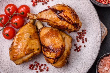 Lezzetli ızgara tavuk bacağı. Baharatlı ve otlu teriyaki soslu. Koyu beton arka planda.