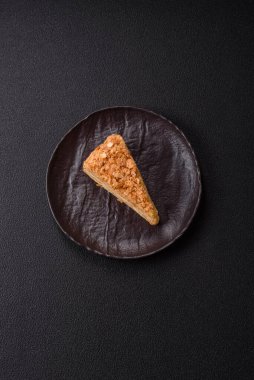 Koyu beton arka planda kremalı Napolyon pastası.