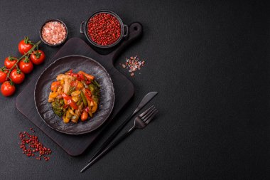 Sebze karışımı mısır, havuç, biber, brokoli, teriyaki soslu soğan koyu beton arka planda seramik bir tabakta