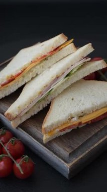 Jambonlu, salamlı, domatesli, hardallı, tuzlu ve baharatlı sandviç.