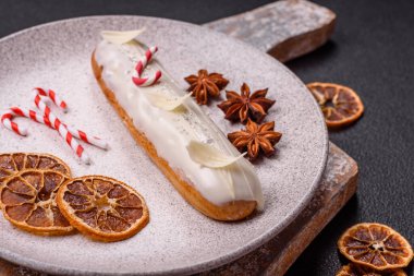 Koyu beton arka planda beyaz jöle ile kaplanmış çikolatalı tatlı ekler.