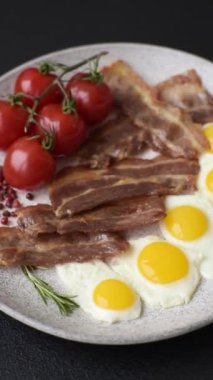 Yağda yumurta, domuz pastırması ve domatesli, tuzlu, baharatlı ve otlu nefis bir kahvaltı.