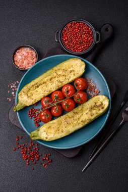 Tuz, baharat ve otlarla pişirilmiş, koyu beton arka planda iki parçaya bölünmüş lezzetli kabak.