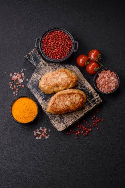 Lezzetli taze kıymalı balık pirzolası. Esmer arka planda baharatlar ve otlarla birlikte.