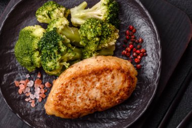 Lezzetli taze brokoli, dokulu beton arka planda seramik bir tabakta buğulanmış.