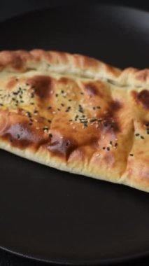 Cheburek etli börek ve şifalı otlar. Siyah beton arka plan. Üst görünüm