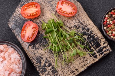Ahşap kesme tahtasının üzerinde yeşil taze bezelye tohumu koyu beton arka planda