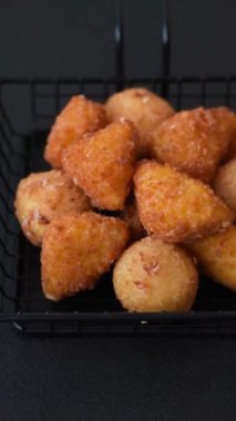 Fast food brie kızartması, peynir topları ve arka planda tavuk nuggetları.