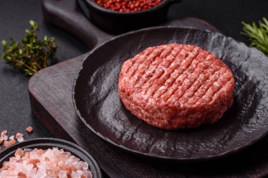 Beton kaplamalı tuzlu ve baharatlı taze çiğ biftek köftesi.