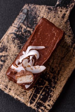 Hindistan cevizi gevrekleri ve koyu beton arka planda sünger keki ile çikolatalı tatlı pasta.