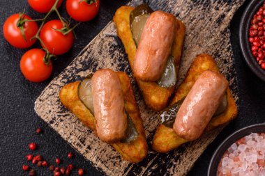 Koyu beton arka planda patates, soğan, tuz ve baharatlı mücver.