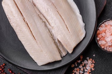 Ringa fileto tuzlu ve tuzlu, baharatlı ve yağlı koyu beton arka planda.