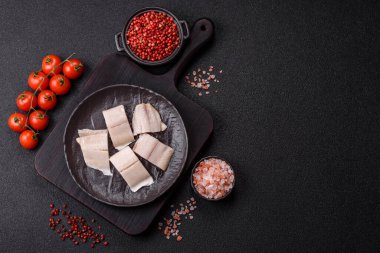 Ringa fileto tuzlu ve tuzlu, baharatlı ve yağlı koyu beton arka planda.