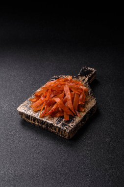 Kurutulmuş hindi eti, tuzlu ve baharatlı koyu beton arka planda.