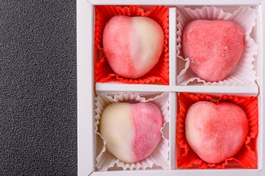 Delicious sweet mochi in the shape of red hearts for the holiday of Valentine's Day clipart