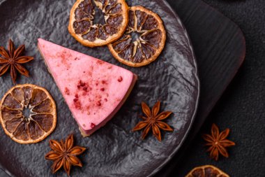 Ahududu ya da çilek aromalı, koyu beton arka planda maskaron peynirli tatlı bir cheesecake.