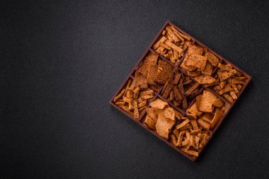 Tohumlar, tanecikler, tuz, baharatlar ve çimento kaplı ev yapımı çıtır kahverengi ekmek cipsleri.